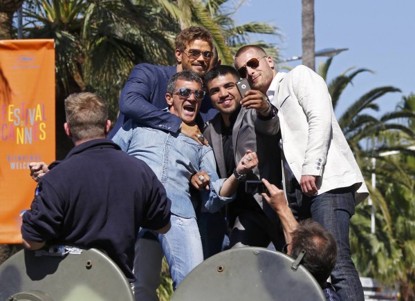 Cast members  Kellan Lutz, Antonio Banderas, Victor Ortiz and Glen Powell make a selfie with a mobile phone as they pose on a tank on the Croisette to promote the film "The Expendables 3" during the 67th Cannes Film Festival in Cannes
